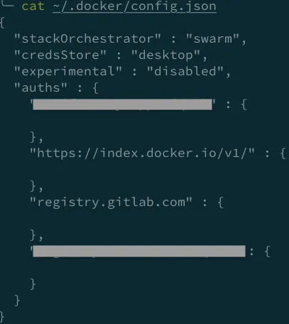 Terminal output of cat ~/.docker/config.json, showing a credsStore entry instead of an embedded auth value